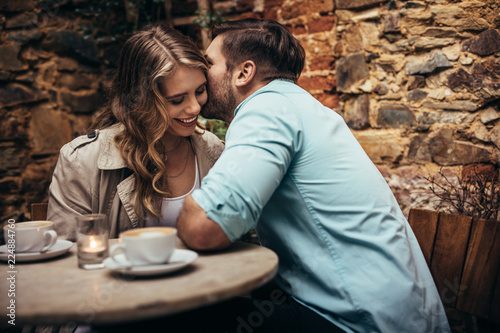 Romantic couple on a date sitting in a restaurant photo