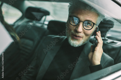 Mature man travelling by a taxi © Jacob Lund