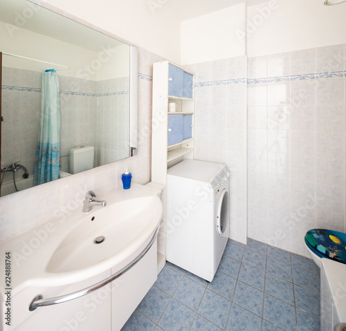 Vintage bathroom with tiles and washing machine