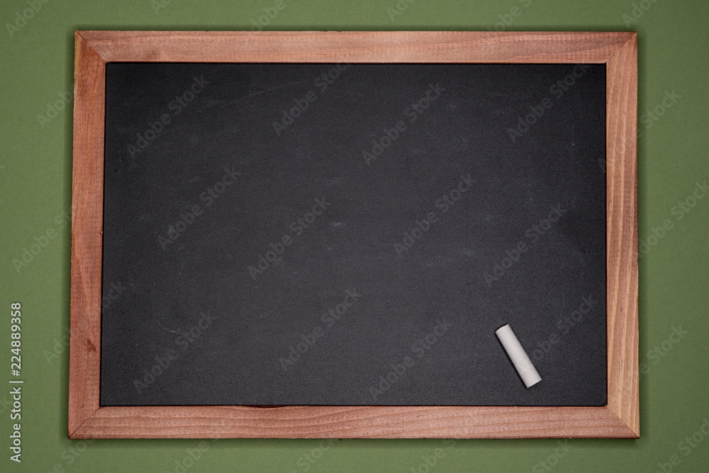 Empty chalk board with wooden frame on green background, blank copy space Empty chalk board with wooden frame on green background, blank copy space