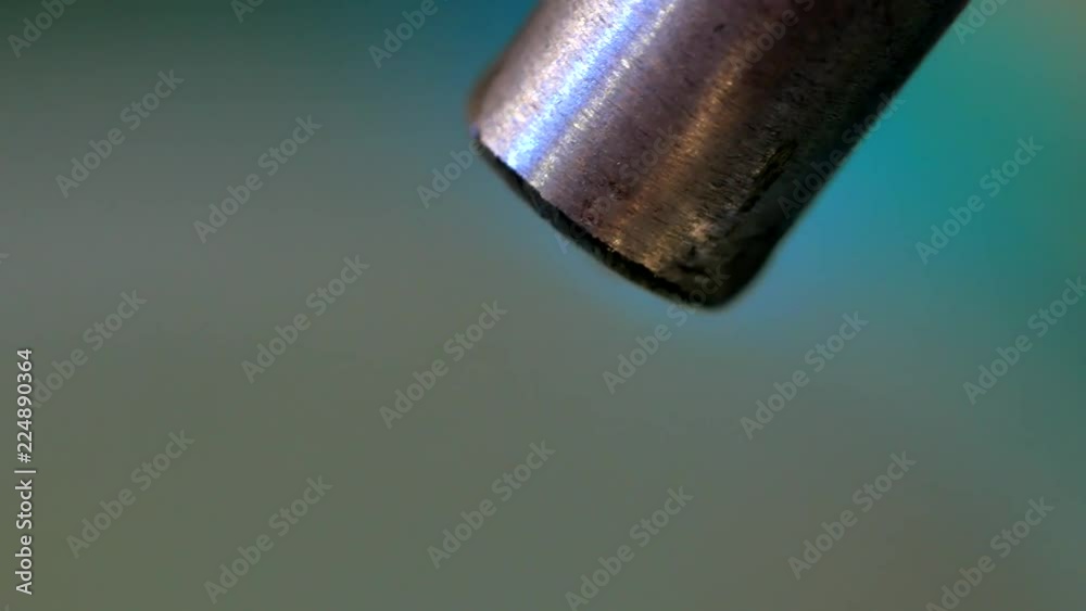 Drops of liquid with metallic tubes on a blue background Drops of liquid with metallic tubes on a blue background