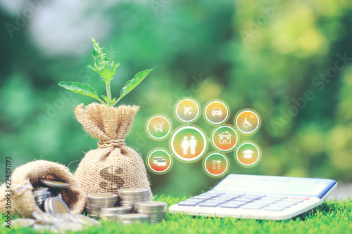 Growing plant on Money bag with stack of coins money and hologram on natural green background, Saving for prepare in future and Business investment concept photo