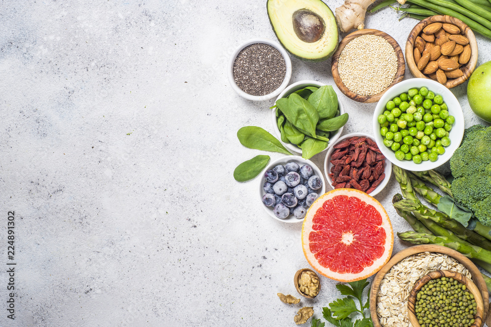 custom made wallpaper toronto digitalSuperfoods on light stone background. Healthy vegan food. 