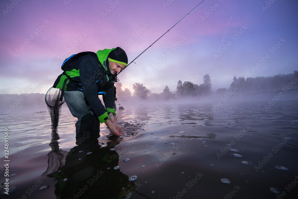 Fisherman giving a freedom to predatory small fish Fisherman giving a freedom to predatory small fish