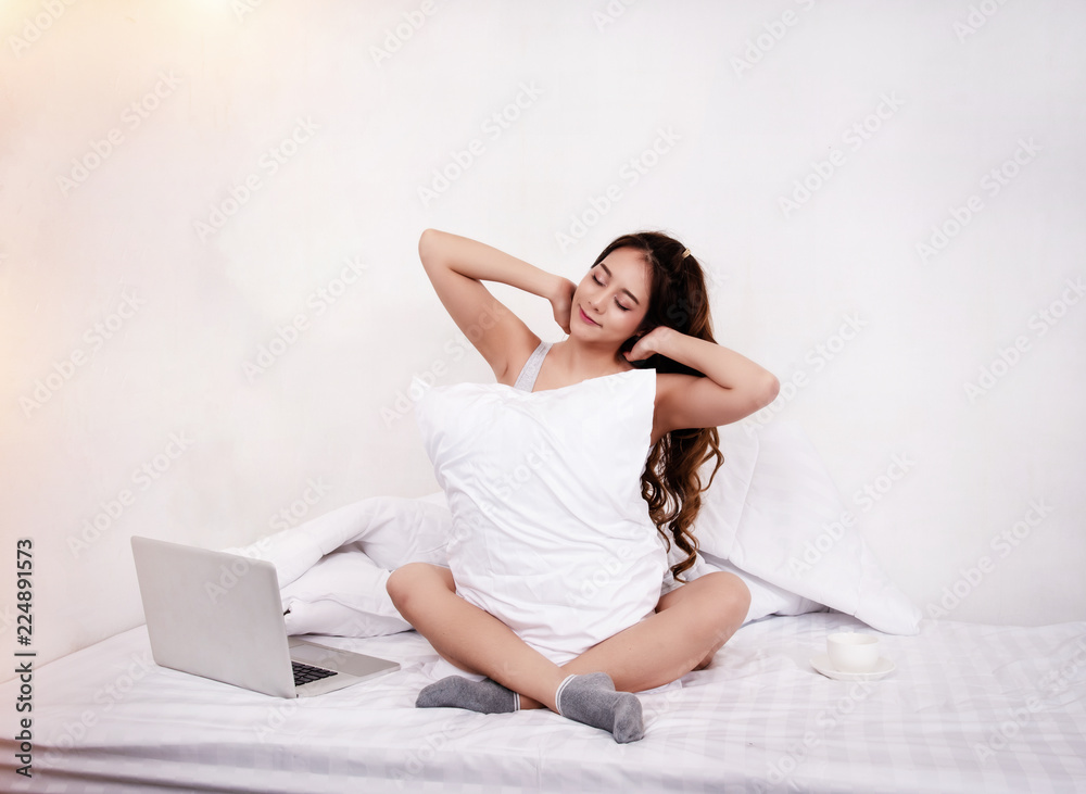 The beauty lady is sitting on bed, wake up in morning time,with smile and happy face,warm light tone,blurry light around The beauty lady is sitting on bed, wake up in morning time,with smile and happy face,warm light tone,blurry light around