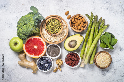 Superfoods on light stone background. Healthy vegan food. 