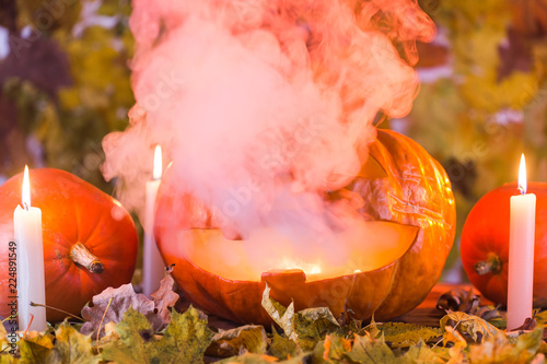 Jack-o-Lantern halloween pumpkin with mist pouring from its mouth photo