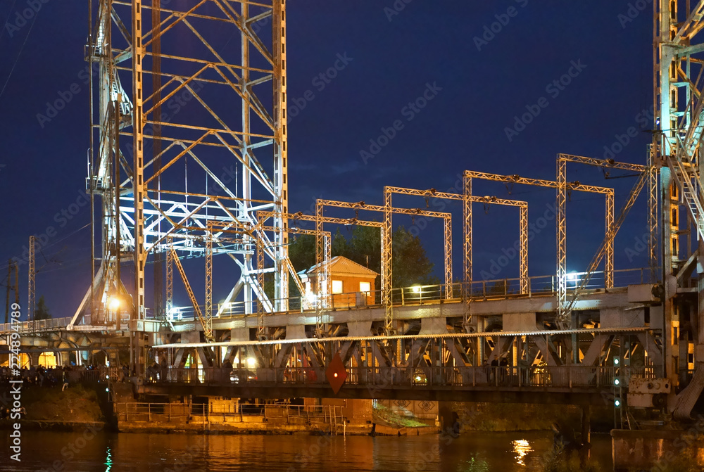Bridge swing night. Boats pass along the river at night.
