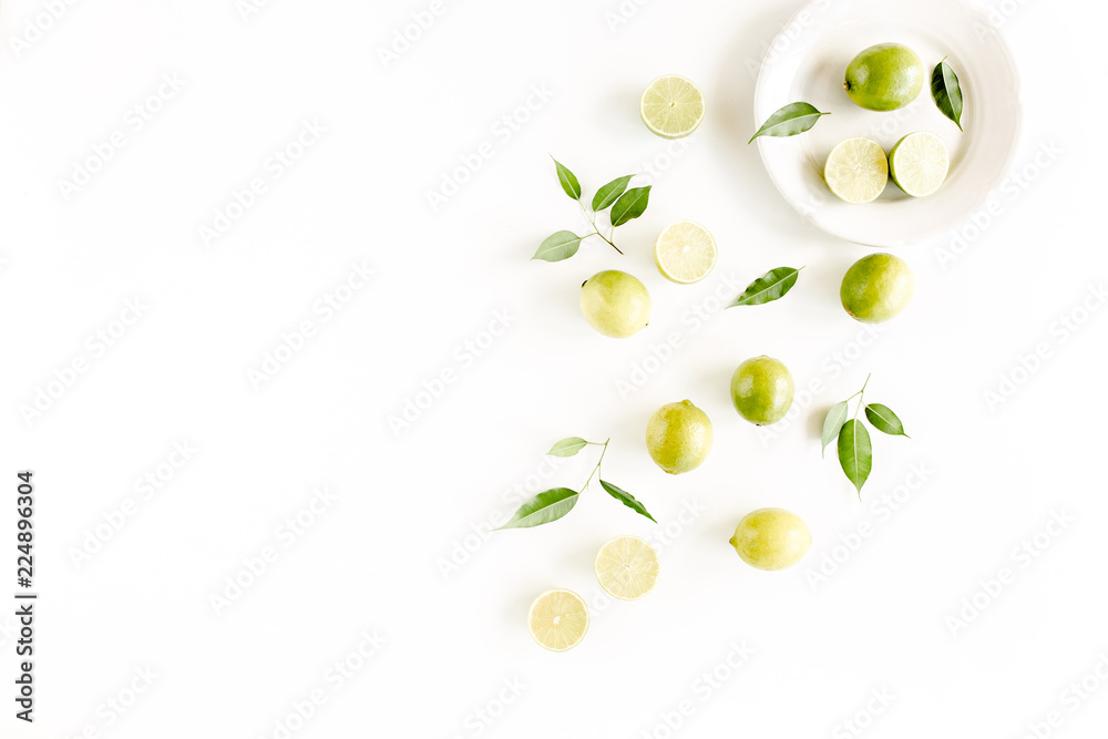 Pattern made of lime and leaves ficus. Food concept. flat lay, top view Pattern made of lime and leaves ficus. Food concept. flat lay, top view