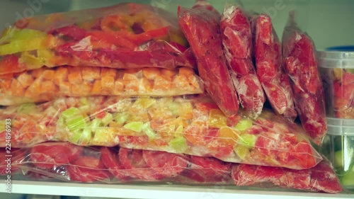 Fridge Organization. Packages and containers with frozen fruits and vegetables. Food storage photo