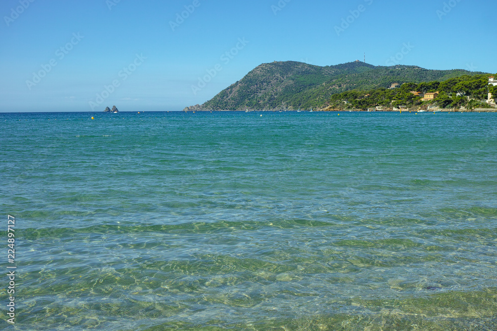 Sunny sandy beach vacation, landscape with clear blue sea shore and sandy beach