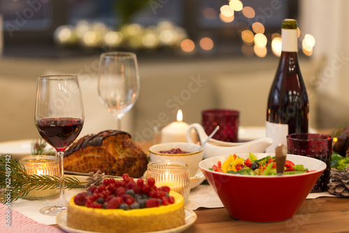christmas dinner and eating concept - food and drinks on table at home