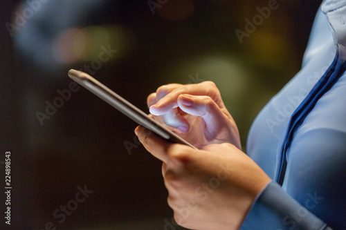 business  technology and people concept - close up of businesswoman hands with smartphone