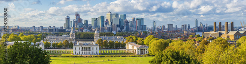 ondon, England, Panoramic Skyline View Of Greenwich College and Canary Wharf At Golden Hour Sunset With Blue Sky And Clouds photo