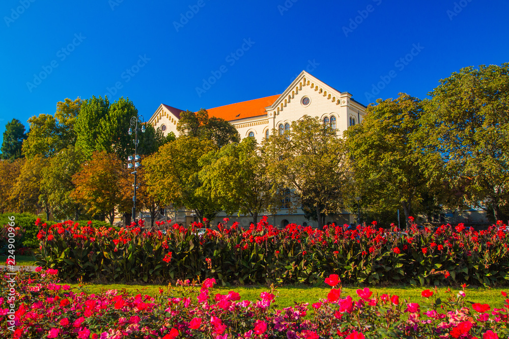 Colorful flowers on and old University building in the background in Zagreb, Croatia