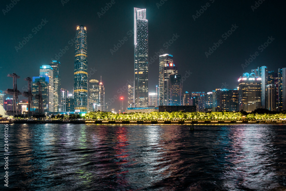 Naklejka premium Wieża astronomiczno-widokowa w Kantonie. Widok zmierzchu wieży Canton z Placu Kwiatów w Guangzhou w Chinach. nowoczesne budynki biurowe w pobliżu rzeki w centrum guangzhou