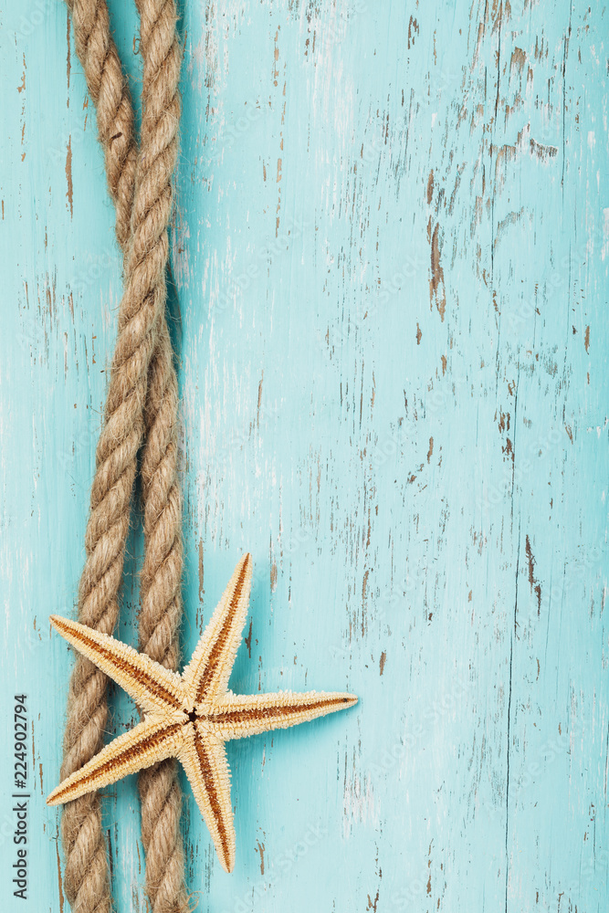 Rope and starfish on the background of an old wooden board with copy space Rope and starfish on the background of an old wooden board with copy space