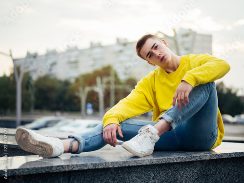 Young attractive man in a yellow sweater