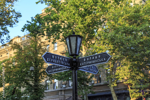 Sign post of famous street deribasivska and katherinska with lamp in Odessa, Ukraine photo