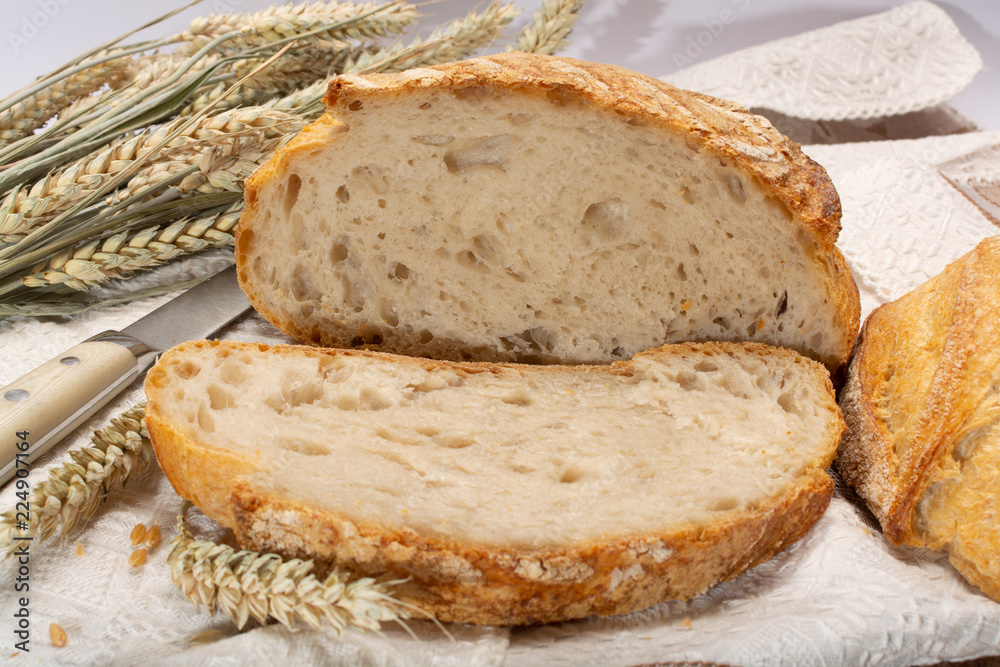 Sourdough homemade round white wheat bread with slices close up Sourdough homemade round white wheat bread with slices close up