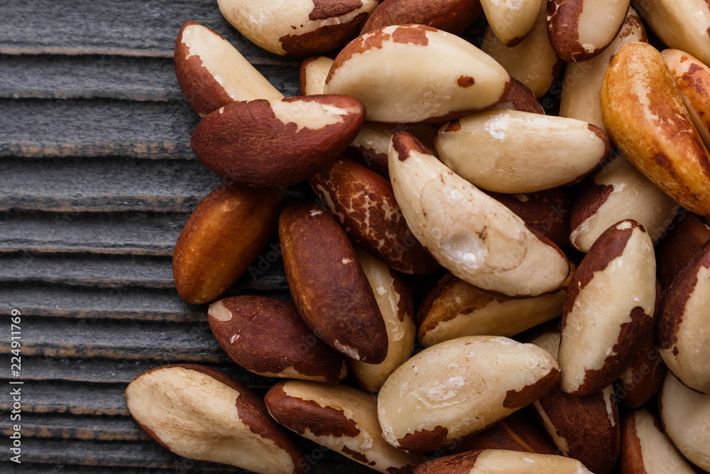 brazil nut on a dark rustic wooden background brazil nut on a dark rustic wooden background