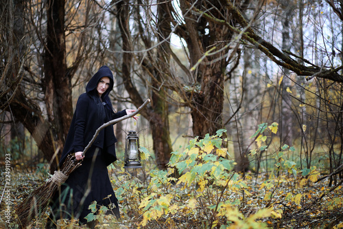 A woman in a witch suit in a forest