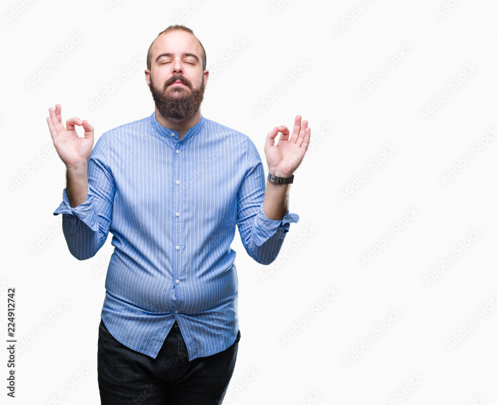 Naklejka premium Young caucasian hipster man over isolated background relax and smiling with eyes closed doing meditation gesture with fingers. Yoga concept.