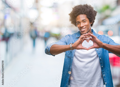Afro american man over isolated background smiling in love showing heart symbol and shape with hands. Romantic concept. © Krakenimages.com