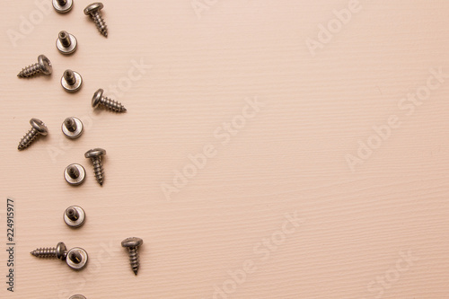 Self-tapping screw on a wooden background 