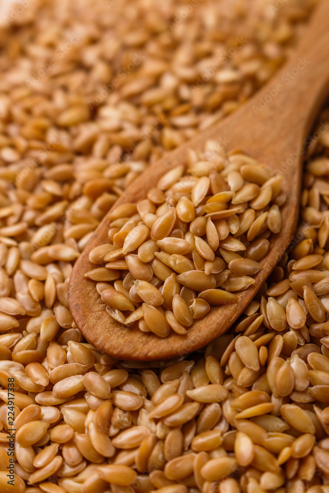 Seeds of golden flax on a white background