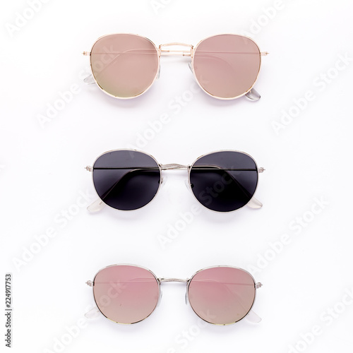 Female sunglasses on white background. Flat lay, top view. 