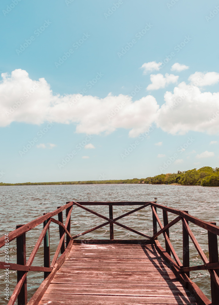 Wood dock on a lake and blue sky
