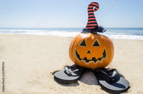 Beach Halloween background with pumpkin in the witch's hats