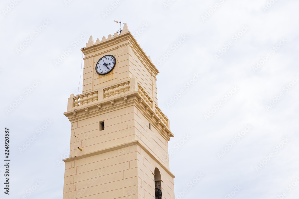 Old clock beige tower in the sky