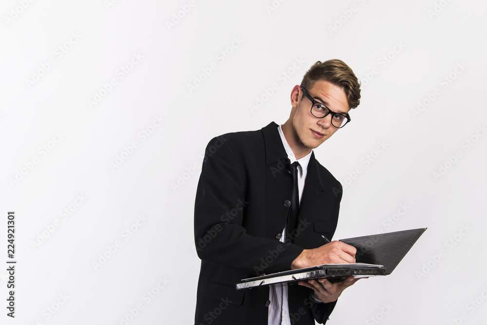 young man in classic black suit with laptop and papers office and business concept young man in classic black suit with laptop and papers office and business concept