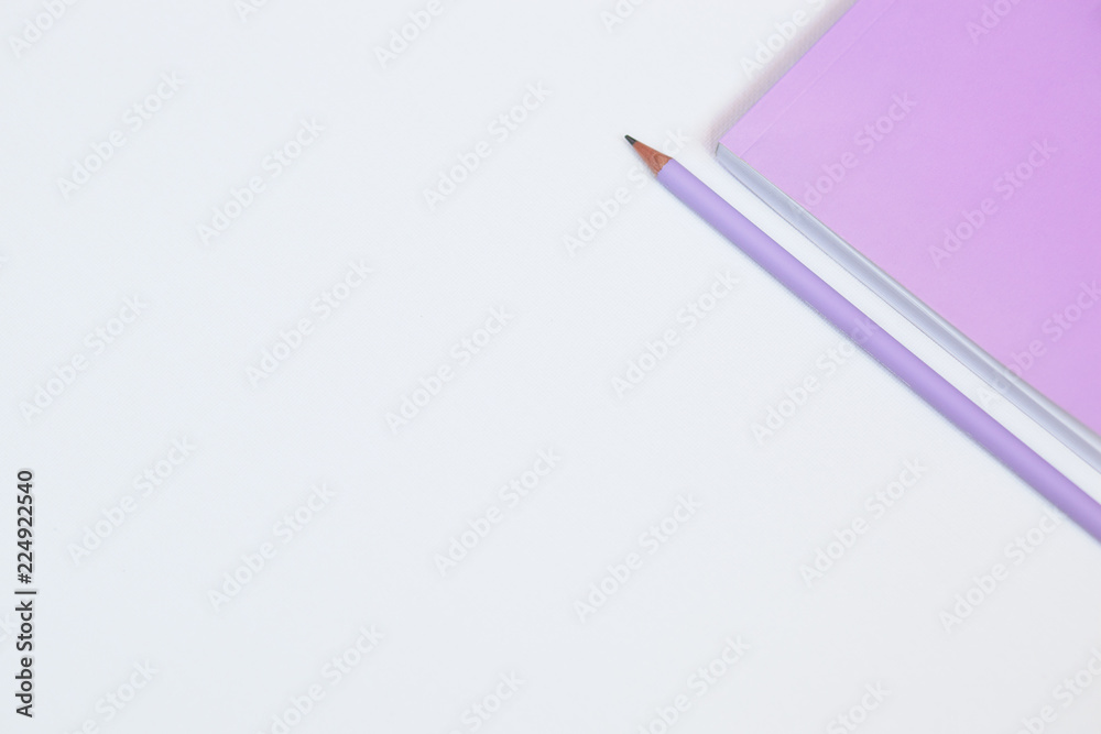 Fototapeta premium Pink notebook and pencil on white background. Selective focus