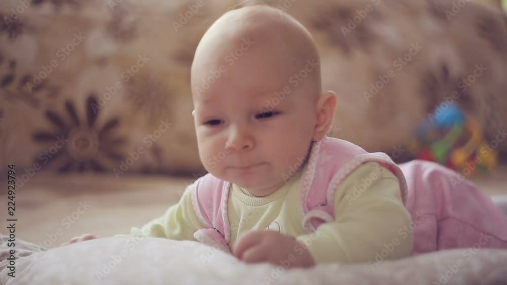 A cute little baby is looking into the camera. A cute little baby is looking into the camera.