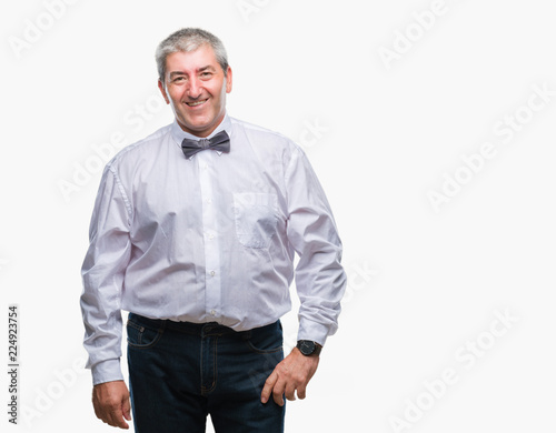 Handsome senior man wearing bow tie over isolated background with a happy and cool smile on face. Lucky person.