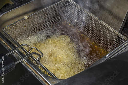 fryer for potatoes with fries with boiling oil. Concept fast food restaurant, kitchen equipment