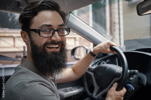  Handsome, happy man driving the car