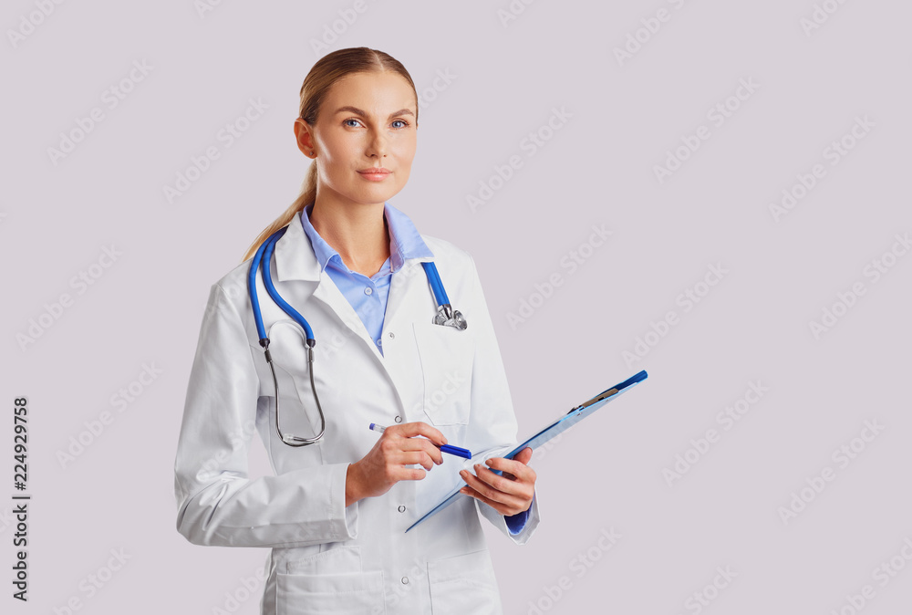 Doctor blonde in lab coat in the clinic on the background for text. Doctor blonde in lab coat in the clinic on the background for text.