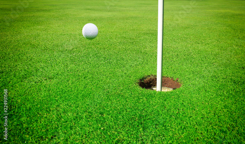A golf ball at the hole