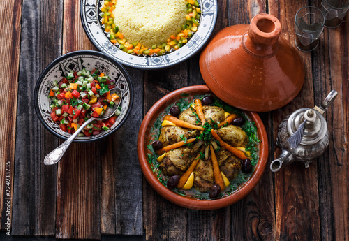 Morrocan cuisine chicken tajine, couscous and salad photo