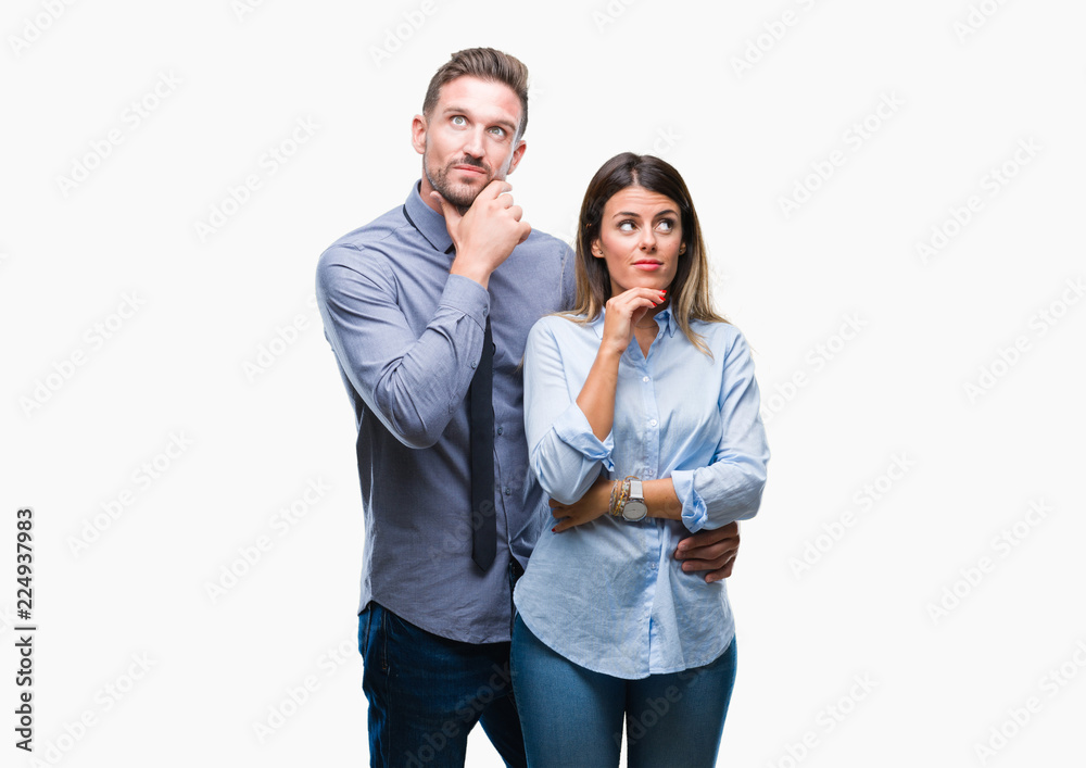 Young workers business couple over isolated background with hand on chin thinking about question, pensive expression. Smiling with thoughtful face. Doubt concept. Young workers business couple over isolated background with hand on chin thinking about question, pensive expression. Smiling with thoughtful face. Doubt concept.