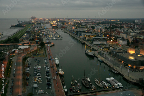 Bremerhaven city panorama of harbor area Havenwelten with harbor 'Neuer Hafen' next to river Weser on a grey November evening photo