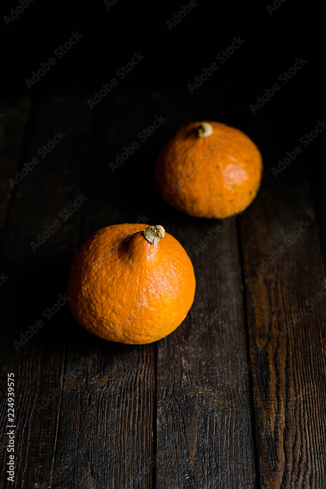 Orange pumpkins on dark wooden background Orange pumpkins on dark wooden background