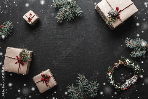 Wallpaper Mural Christmas composition. Xmas or New Year gifts and fir twigs on a black background. Copy space, flat lay Torontodigital.ca