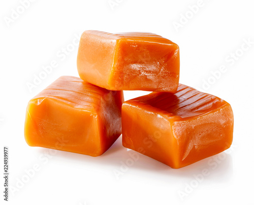 three toffee caramel candies close-up isolated on white background 
