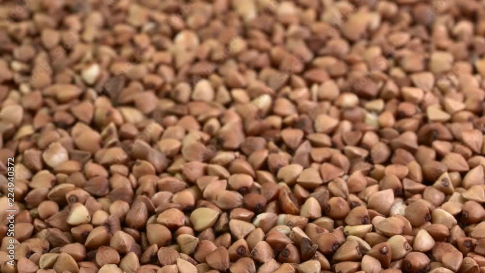 closeup of gluten free buckwheat roasted kasha - rotating background, low angle view closeup of gluten free buckwheat roasted kasha - rotating background, low angle view