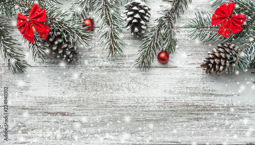 Wallpaper Mural Christmas theme with fir branches, cones, globes, red bows on white wooden background viewed from above, in snow, greeting card with space for text Torontodigital.ca